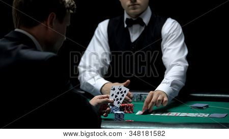 Upset Casino Client Having Bad Cards Combination In Poker, Weak Hand House Wins