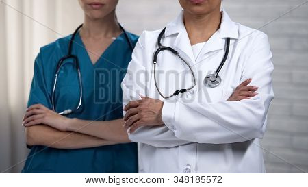 Medical Co-workers Crossing Hands, Professionals Always Ready To Help Patient
