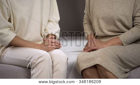 Close-up Women Sitting On Couch Having Important Conversation, Family Relations