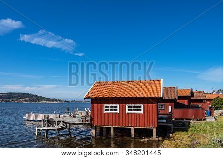 Boathouses Near The City Fjaellbacka In Sweden.