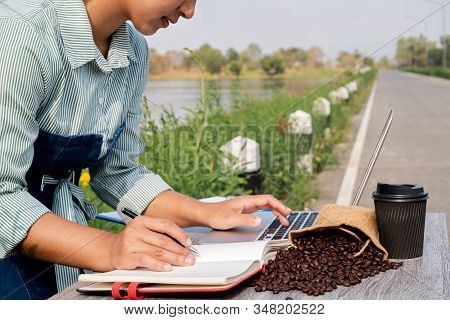 The Woman Inspected The Coffee Bean Quality And Recorded The Results.