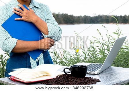 The Woman Inspected The Coffee Bean Quality And Recorded The Results.