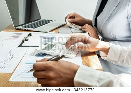 Two Business Leader Discussing The Charts And Graphs Showing The Results, Planning To Start New Stra
