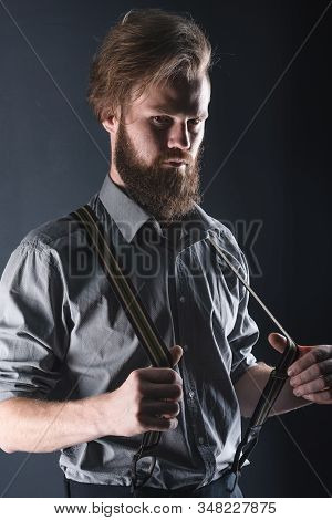 Young, Handsome Man With A Beard Posing On A Black Background In The Studio.