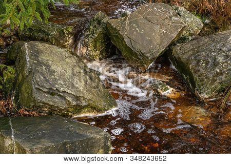 Water Of A Babbling Brook Between Rocks And Stones