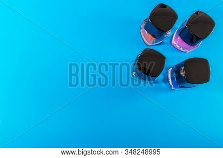 Four Gel Polishes On Blue Background