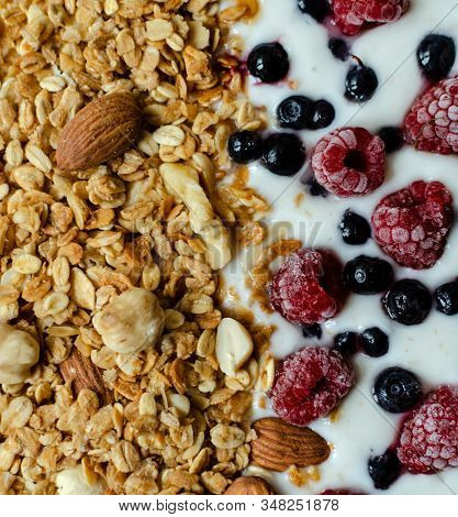 Healthy Breakfast, Granola With Yogurt And Frozen Raspberries And Blueberries, Closeup
