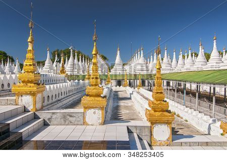 Golden Sandamuni Pagoda With Row Of White Pagodas. Amazing Architecture Of Buddhist Temples At Manda