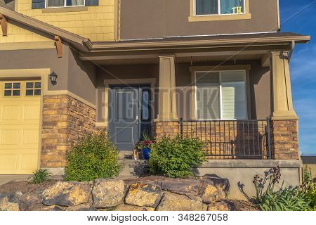 Home Entrance With Front Porch Gray Door Sidelight And Garage With Gable Roof