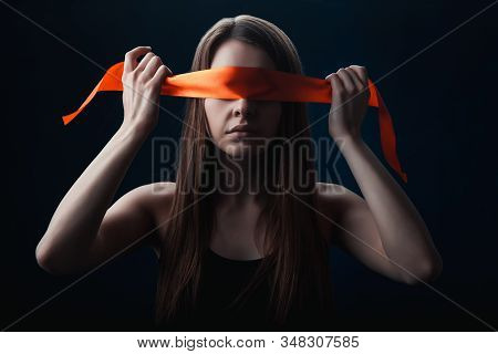 The Girl Blindfolded Herself, With Red Tape, A Game On A Black Background