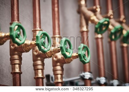 Plumbing service. copper pipeline of in boiler room. valves in row