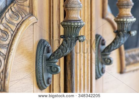 Old Bronse Handles On A Wooden Door With Carved Ornament