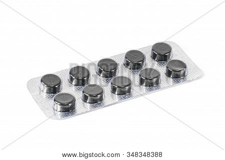 Activated Carbon Blister Tablets For The Treatment Of Diarrhea On A White Background Black Pills