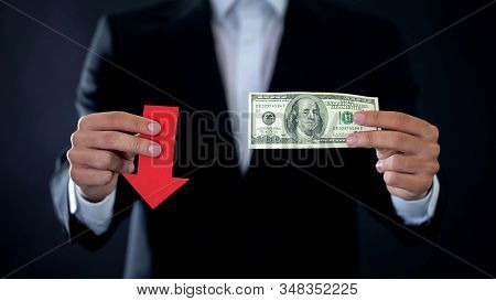 Businessman Showing Dollar Banknote And Red Arrow Sign Falling, Financial Crisis