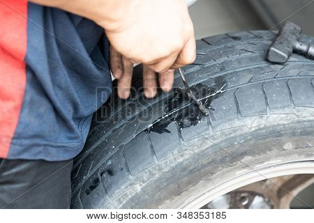 Series Of Mechanic Patching Puncture Tubeless Tire. Plugs Being Inserted Into Puncture Area.