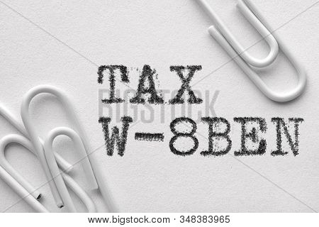 White Plastic Paper Clips With Tax W-8ben Words Printed By Typewriter