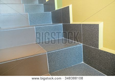 Wide Staicase Covered With Ceramic Tiles Indoors In A House Interior.