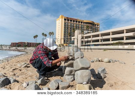 Juan Manuel Cisneros Carefully Places The Next Rock While Constructing An Arch Engineered From River
