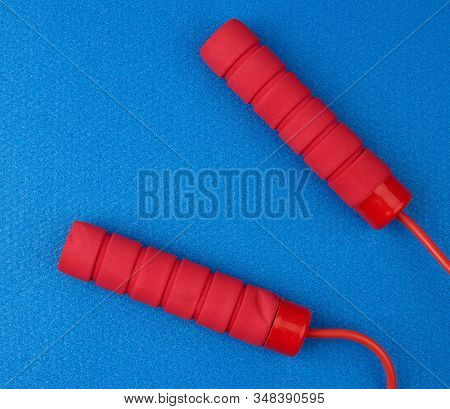 Neoprene Handles Red Rope Lying On A Blue Neoprene Sports Matclose Up