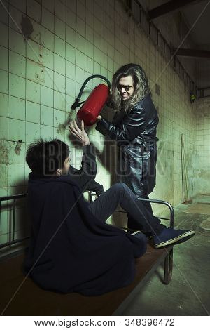 Evil Kidnapper Holding And Controlling Young Man In Horror Place