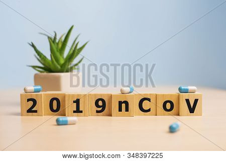 The Inscription 2019ncov On Wooden Cubes, Blue Background. Health Concept, Chinese 2019 Virus-ncov.