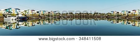 Super Panoramic Waterfront Maritime Marina/dock With Boats In Tropical Water With Blue Sky Backdrop.