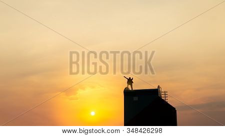 Silhouette Of Man On Rofftop Over Sky And Sun Light Background,business, Success, Leadership, Achiev