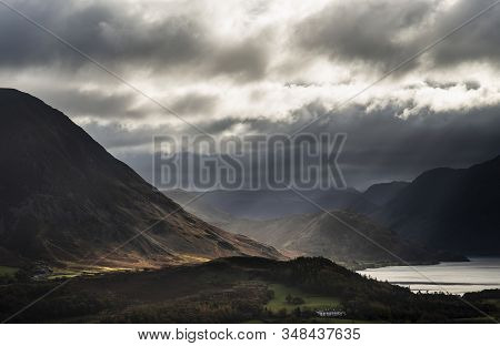Epic Sun Beams Light Up Crummock Water In Dramatic Autumn Fall Landscape Image With Mellbreak And Gr