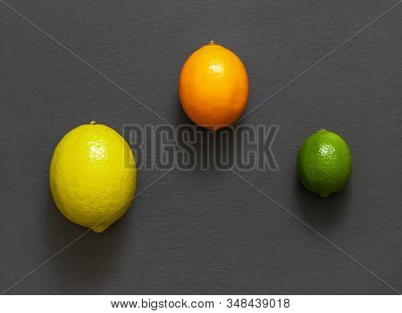 Citrus Fruit On A Stone Table. Juicy Ripe Lemon, Citrus Meyeri And Lime On Grey Background. Food Bac