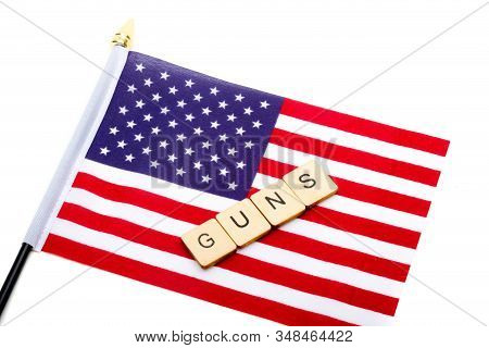 The Flag Of The United States Isolated On A White Background With A Sign Reading Guns