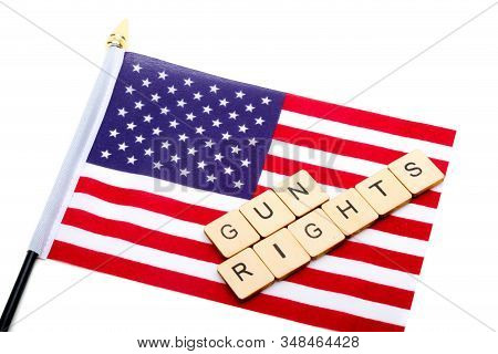 The Flag Of The United States Isolated On A White Background With A Sign Reading Gun Rights