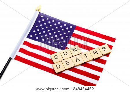 The Flag Of The United States Isolated On A White Background With A Sign Reading Gun Deaths