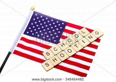 The Flag Of The United States Isolated On A White Background With A Sign Reading School Shooting