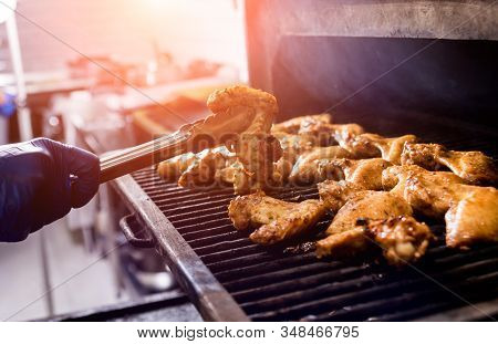 Fried Chiken Wings At Grill Barbecue. Restaurant.