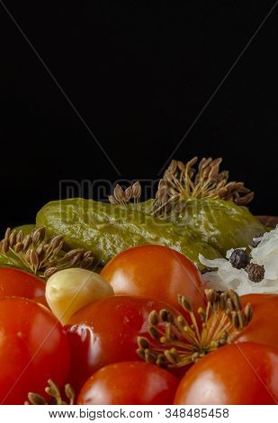 Vertical View. Portion Of Homemade Pickles Of Cucumbers, Tomatoes, Cabbage And Dill Flowers On A Bla