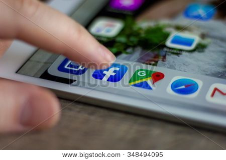 Brecht, Belgium - November 14 2019: A Portrait Of A Finger Of A User Above The Facebook Application 