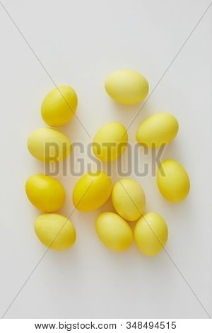 Top View Of Pastel Yellow Easter Eggs Arraigned In Minimal Composition On White Background, Copy Spa