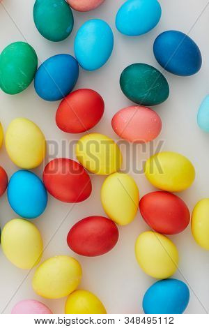 Above View Of Multi Colored Easter Eggs Arraigned In Minimal Composition On White Background, Copy S