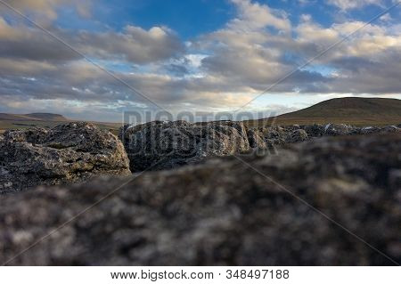 A Low View Detail Of Limestone Pavement With Penyghent And Ingleborough In The Background
