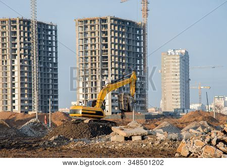 Excavator With Crusher Bucket For Crushing Concrete. Construction Waste Recycling At Construction Si