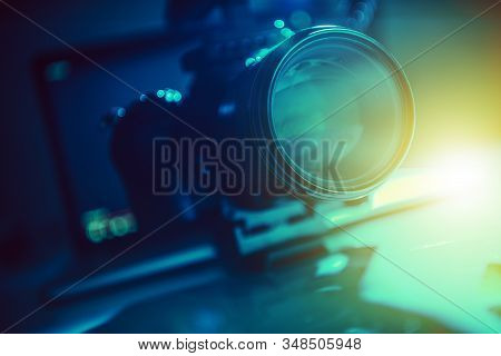Modern Video Production Equipment. Telephoto Lens Closeup Photo. Dark Blue And Greenish Theme. Motio