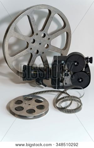 Black Movie Camera. Close Up On A White Background. Isolate View From The Side Where The Lid Of The 