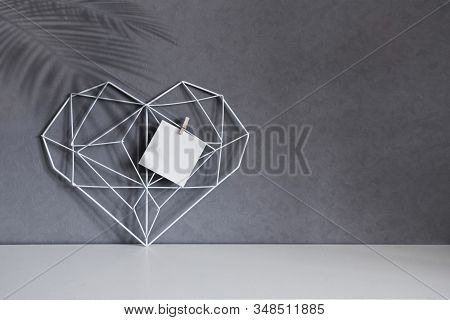 Home Decorative Frame In The Form Of A Heart On A Background Of Gray Wall, Interior. Concept Symbol 