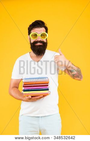 Colorful Stationery. Stationery Admirer. Buy Sketchbooks. Hipster Eccentric Guy Hold Pile Notepads. 