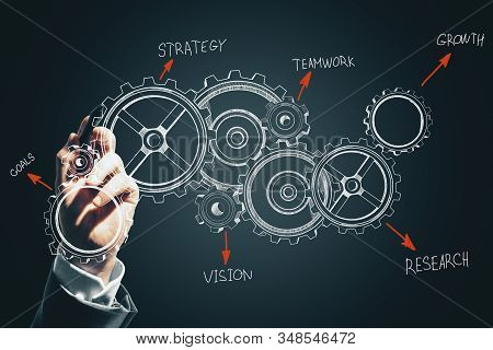 Hand Drawing Cogs And Gears System Sketch On Gtay Background. Teamwork And Business System Concept. 