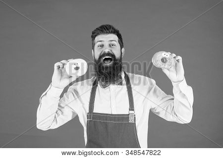 At Baker Shop. Mature Man Red Backdrop. Skilled Baker With Donut Dessert. Funny Hipster Cook Doughnu