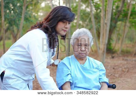 Doctor Help And Care Asian Senior Or Elderly Old Lady Woman Patient Sitting On Wheelchair At Park In