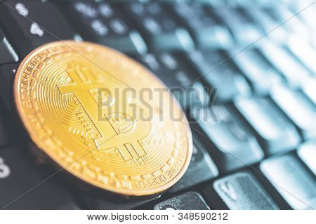 A Bitcoins Coin Represent Digital Future Money On Computor Keyboard As Background With Copyspace. Cr