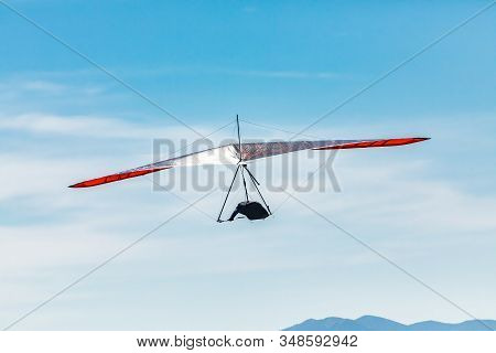 Flying Hang Glider Man In Action. Hang Gliding In Creston, British Columbia, Canada. One Glider Flyi