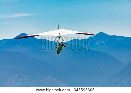 Hang Gliding Over Great Mountains. Soaring Flight Of Hang-glider Pilot Over Kootenay Valley Mountain